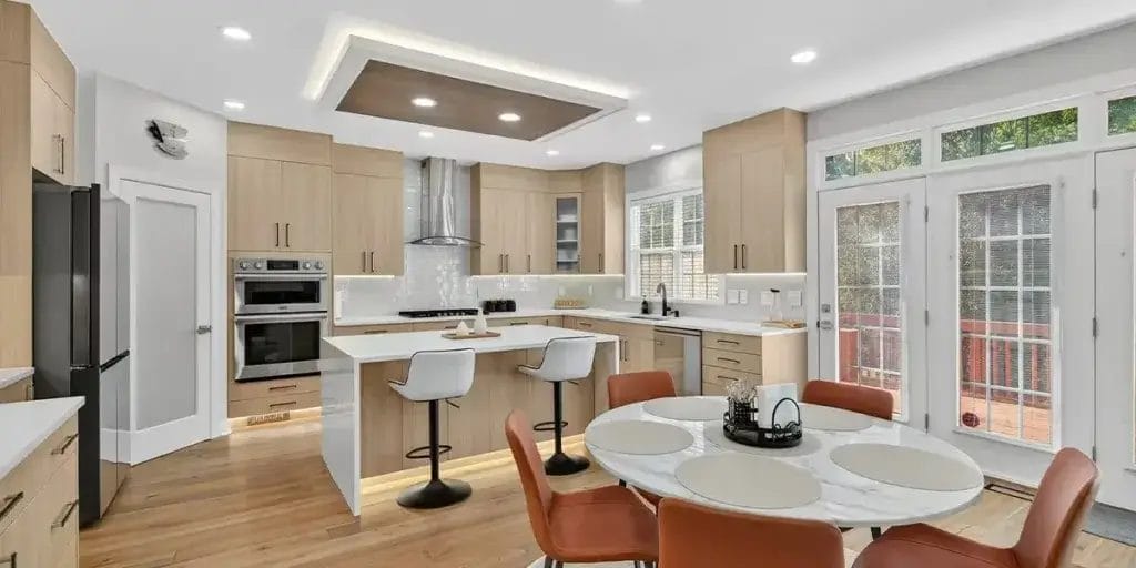 Cabinet - Light colored Kitechen Cabinets Bright open-concept kitchen with light wood cabinets, white island, and marble dining table